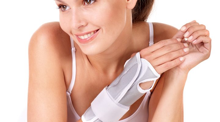 Woman with wrist brace. Isolated.